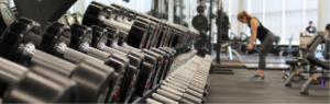 Dumbbells and lady working out in gym