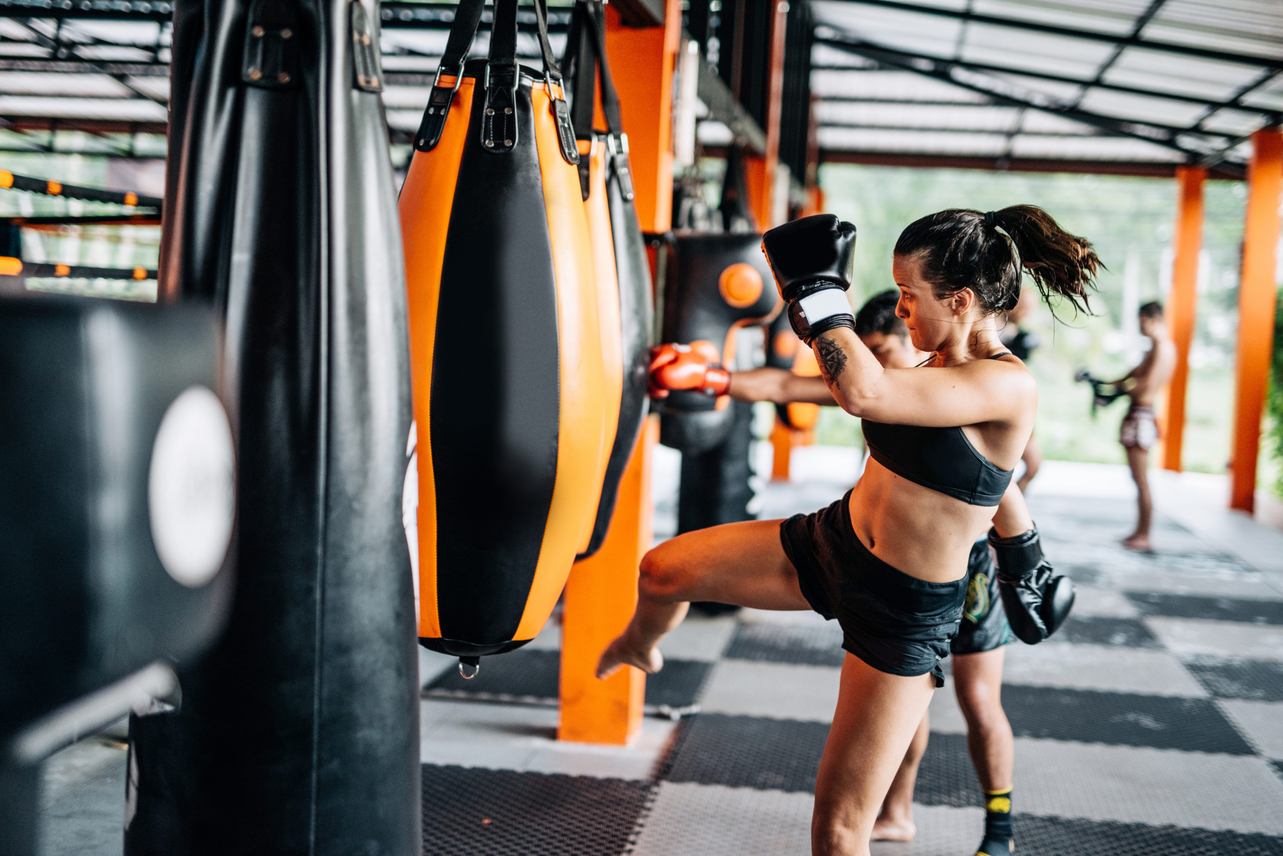 Woman kicking the punch bag